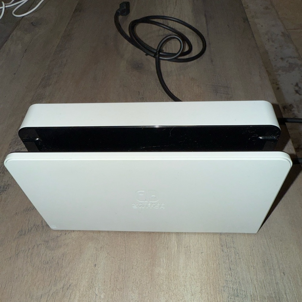 Nintendo Switch Oled Dock in White and Black Dock with HDMI cord.